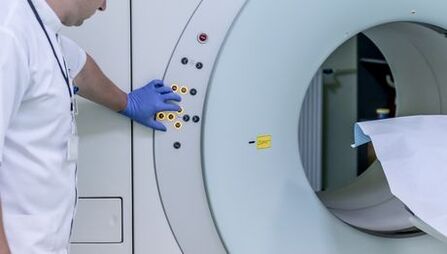The doctor checks the MRI device